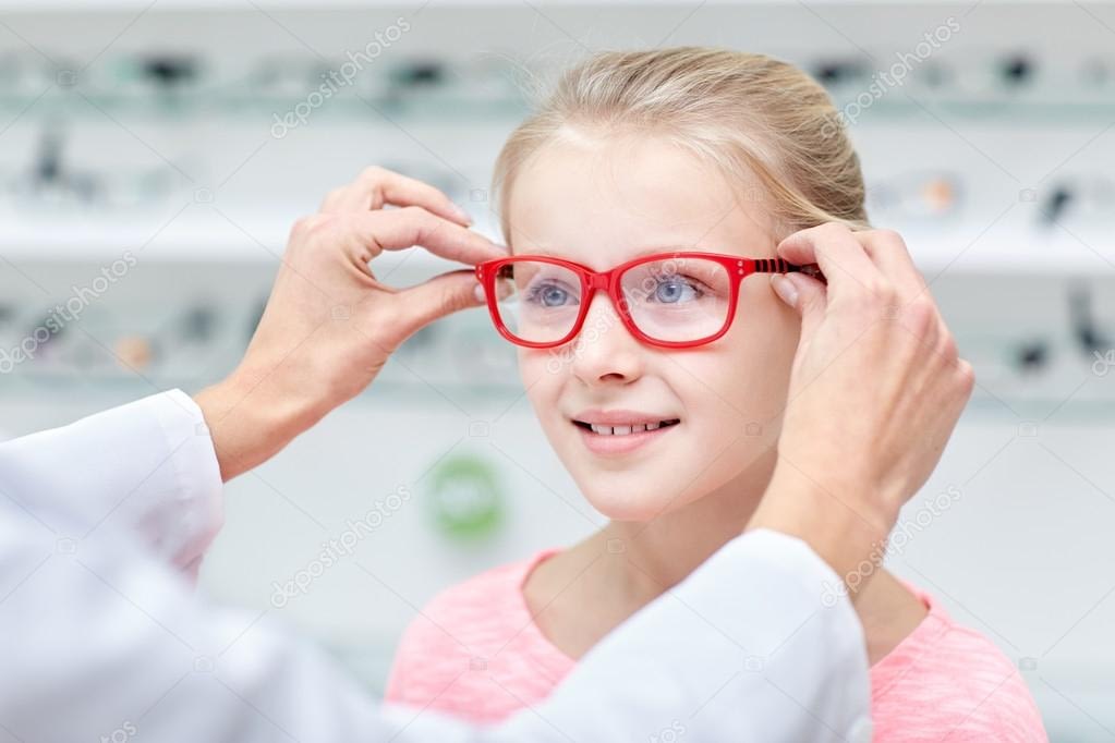 depositphotos_96287382-stock-photo-optician-putting-glasses-to-girl