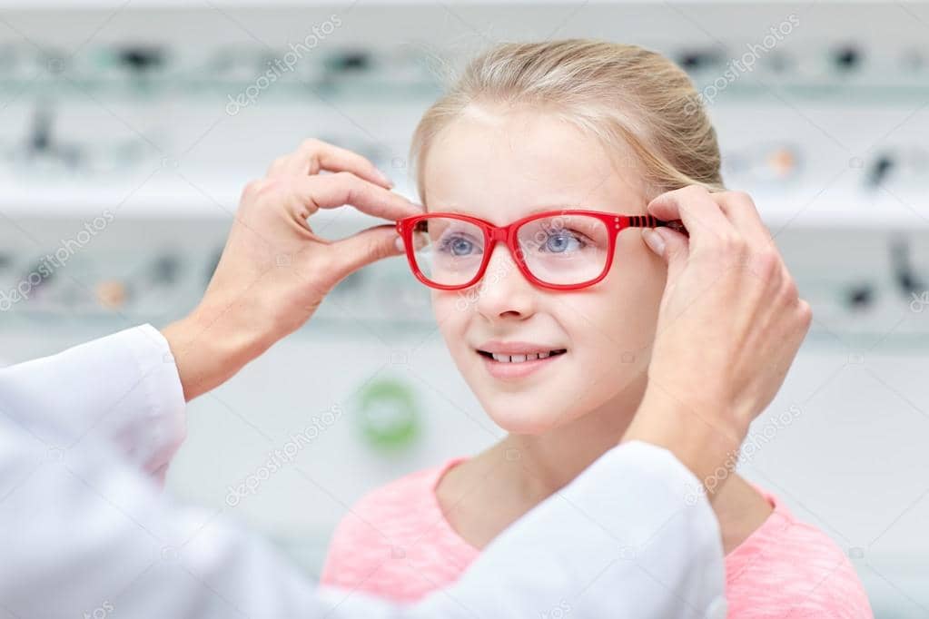 depositphotos_96287382-stock-photo-optician-putting-glasses-to-girl